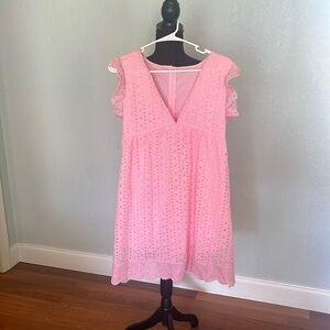 Pink eyelet romper with built in shorts/liner.  Size medium.